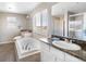 Bathroom with a soaking tub, a double sink vanity with granite countertop, and a walk-in shower at 13742 Valentia St, Thornton, CO 80602