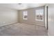 Bedroom featuring neutral walls, carpet, and two windows that offer ample natural light at 13742 Valentia St, Thornton, CO 80602