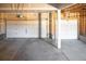 Spacious garage with two white garage doors and a concrete floor, offering ample parking and storage at 13742 Valentia St, Thornton, CO 80602