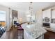 Open-concept kitchen featuring granite countertops, stainless steel appliances, and a seamless transition to the living area at 13742 Valentia St, Thornton, CO 80602