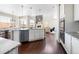 Kitchen with island, stainless steel appliances, and a clear view into the adjacent dining and living areas at 13742 Valentia St, Thornton, CO 80602