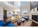 Open-concept living room with high ceilings, abundant natural light, and seamless flow to the modern kitchen and dining space at 13742 Valentia St, Thornton, CO 80602