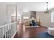 Spacious living room showcasing a striking fireplace, elegant furnishings, and an open layout to the kitchen and dining areas at 13742 Valentia St, Thornton, CO 80602