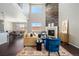 Bright living room showcasing a cozy fireplace with stylish decor and an adjacent dining area, perfect for entertaining at 13742 Valentia St, Thornton, CO 80602