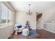 Cozy sitting area featuring a comfortable chair, stylish decor, and ample natural light from the large window at 13742 Valentia St, Thornton, CO 80602