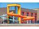 A community water park with vibrant orange and blue slides attached to a modern building for Gathering fun at 13742 Valentia St, Thornton, CO 80602
