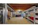 View of unfinished basement with open joists and ample storage space at 10532 Madison St, Thornton, CO 80233