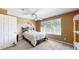 Comfortable bedroom with a large window, ceiling fan and a bed with a dark wood frame at 10532 Madison St, Thornton, CO 80233