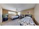 Bedroom with two beds, a desk, a fan, and a TV, creating a cozy and functional area at 10532 Madison St, Thornton, CO 80233