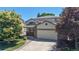 Exterior of two-story home featuring a brick front, two-car garage, and a well-maintained lawn at 10532 Madison St, Thornton, CO 80233