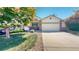 Exterior of two-story home featuring a brick front, two-car garage, and a well-maintained lawn at 10532 Madison St, Thornton, CO 80233