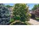 Exterior of two-story home featuring a brick front, two-car garage, and mature trees at 10532 Madison St, Thornton, CO 80233