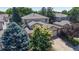 Beautiful two-story home with mature trees, a driveway, and an attached garage at 10532 Madison St, Thornton, CO 80233