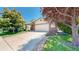 Exterior of two-story home featuring a brick front, two-car garage, and a well-maintained lawn at 10532 Madison St, Thornton, CO 80233