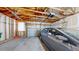 View of the garage with exposed joists and a vehicle at 10532 Madison St, Thornton, CO 80233