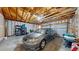 View of the garage with exposed joists, storage and a vehicle at 10532 Madison St, Thornton, CO 80233