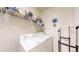 Well-organized laundry room with modern washer and dryer units, and ample shelf space at 10532 Madison St, Thornton, CO 80233