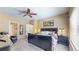 Spacious main bedroom with a ceiling fan, a large window, and dark wood furniture at 10532 Madison St, Thornton, CO 80233