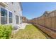 Fenced backyard with small grass area and a concrete patio at 3338 Ireland Moss St, Castle Rock, CO 80109