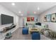Cozy basement featuring comfortable seating, a large television, and stylish decor at 3338 Ireland Moss St, Castle Rock, CO 80109