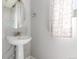 Charming bathroom with a pedestal sink and decorative mirror at 3338 Ireland Moss St, Castle Rock, CO 80109