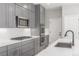 Gray cabinets, stainless steel appliances, and quartz countertops in a modern kitchen at 3338 Ireland Moss St, Castle Rock, CO 80109