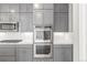 Contemporary kitchen featuring gray cabinets and stainless steel appliances at 3338 Ireland Moss St, Castle Rock, CO 80109