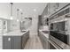 Open kitchen with gray cabinets, stainless steel appliances, and quartz countertops at 3338 Ireland Moss St, Castle Rock, CO 80109