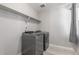Convenient laundry room featuring modern washer and dryer units with overhead shelving at 3338 Ireland Moss St, Castle Rock, CO 80109