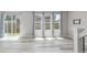 Large open living room with modern lighting, lots of light and new floors at 3338 Ireland Moss St, Castle Rock, CO 80109