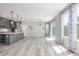 Open concept living space connecting to kitchen, featuring light-colored flooring and natural light at 3338 Ireland Moss St, Castle Rock, CO 80109