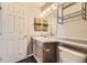 Cozy bathroom with wood cabinets and bright vanity lighting at 4899 S Dudley St # 20G, Littleton, CO 80123