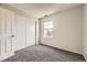 Bedroom with neutral walls, carpet, and closet with sliding doors at 4899 S Dudley St # 20G, Littleton, CO 80123