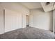 Bedroom with neutral walls, carpet, and closet with sliding doors at 4899 S Dudley St # 20G, Littleton, CO 80123