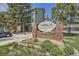 Community sign at Chestnut 4899, showing lush greenery and landscaping at the building entrance at 4899 S Dudley St # 20G, Littleton, CO 80123