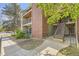 Exterior view of the apartment featuring a brick chimney, balcony, and access stairs at 4899 S Dudley St # 20G, Littleton, CO 80123