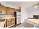 Bright kitchen featuring wood cabinets, stainless steel refrigerator, and dining area at 4899 S Dudley St # 20G, Littleton, CO 80123