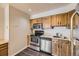 Kitchen featuring stainless steel appliances, wood cabinets and vinyl flooring at 4899 S Dudley St # 20G, Littleton, CO 80123
