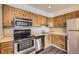 Updated kitchen featuring stainless steel appliances, wooden cabinets and vinyl flooring at 4899 S Dudley St # 20G, Littleton, CO 80123