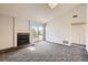 Bright living room featuring a fireplace, carpet flooring, and sliding glass doors to balcony at 4899 S Dudley St # 20G, Littleton, CO 80123