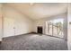 Living room with fireplace, carpet flooring, balcony access, and natural light at 4899 S Dudley St # 20G, Littleton, CO 80123