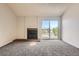Cozy living room featuring carpet, fireplace, and a sliding glass door leading to a balcony at 4899 S Dudley St # 20G, Littleton, CO 80123