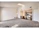 Open floor plan with carpeted living room and eat-in kitchen with bar countertop at 4899 S Dudley St # 20G, Littleton, CO 80123