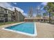 Outdoor community pool with crystal clear water, featuring a bath house and surrounded by lush landscaping at 4899 S Dudley St # 20G, Littleton, CO 80123