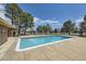 Community pool with a spacious patio, surrounded by mature trees and offering a relaxing recreational space at 4899 S Dudley St # 20G, Littleton, CO 80123