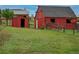 A bright red barn and a storage shed on a well-maintained grassy field at 2501 Remington Rd, Elizabeth, CO 80107