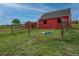 A red barn with a charming storage shed situated on a lush grassy field at 2501 Remington Rd, Elizabeth, CO 80107