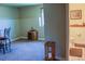 Basement area with carpeting, a wooden side table, and an adjoining bathroom at 2501 Remington Rd, Elizabeth, CO 80107
