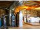 Exposed basement with plumbing, HVAC system, and laundry area with wood accent wall at 2501 Remington Rd, Elizabeth, CO 80107
