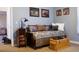 Bedroom with blue walls, daybed, and wildlife artwork at 2501 Remington Rd, Elizabeth, CO 80107